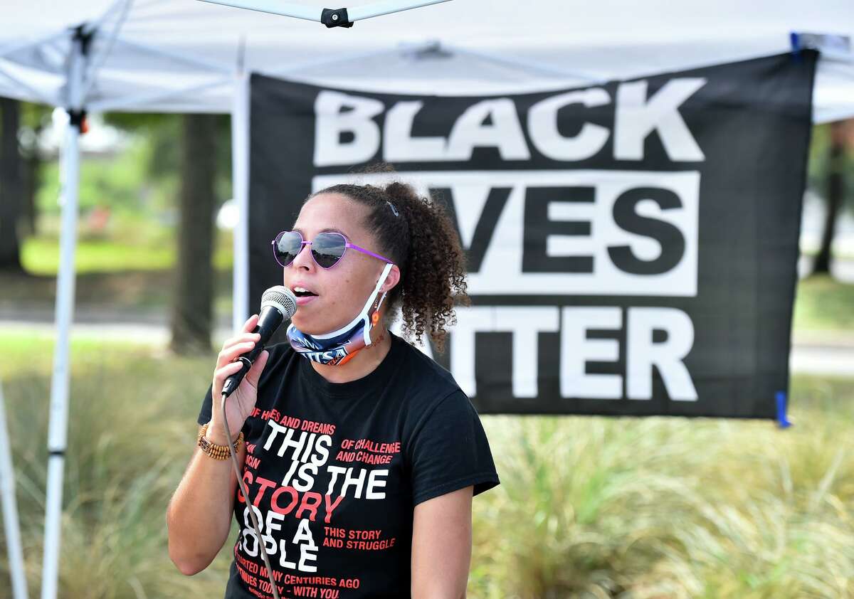 Ananda Tomas speaks during a Black Lives Matter National Day of Action car caravan and food drive that began at the ATT Center and traversed along Commerce Street to Monterey Park on the west side.