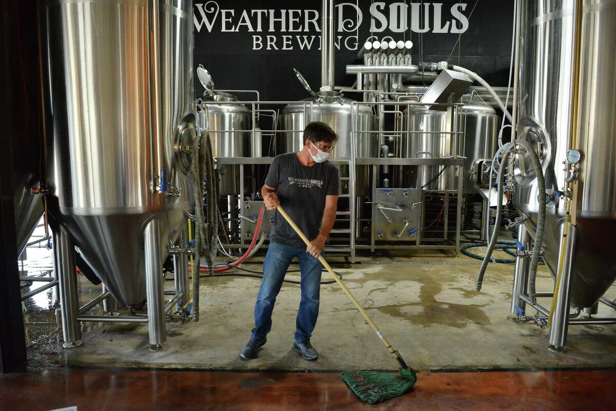 Mike Holt of Weathered Souls Brewery cleans up prior to a presentation in which the brewery presented a check for $20,000 to 100 Black Men of San Antonio in 2020.
