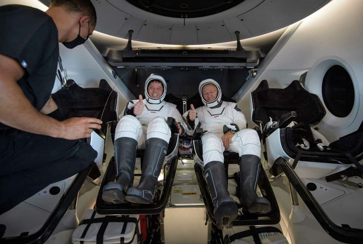 NASA astronauts Bob Behnken, left, and Doug Hurley are seen inside the SpaceX Crew Dragon capsule spacecraft which landed in the Gulf of Mexico after completing the Demo-2 mission to the International Space Station on August 2, 2020 off the coast of Pensacola, Florida. (Photo by Bill Ingalls/NASA via Getty Images)