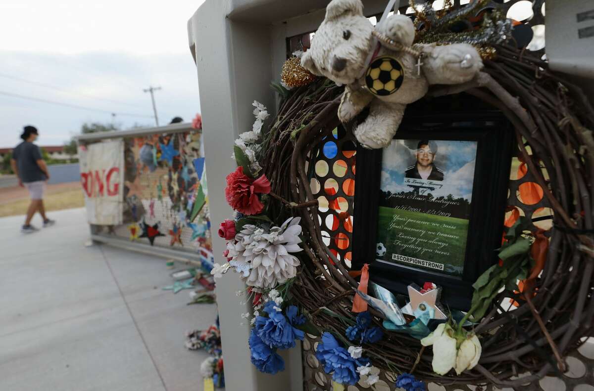 A wreath and photo honors 15-year-old victim Javier Amir Rodriguez (R) at a temporary memorial in Ponder Park honoring victims of the Walmart shooting which left 23 people dead in a racist attack targeting Latinos on August 2, 2020 in El Paso, Texas. August 3rd marks the one-year anniversary of the deadliest attack against Hispanics in modern U.S. history. A number of memorial events are planned amid the COVID-19 pandemic in the Texas city which sits along the U.S.-Mexico border. (Photo by Mario Tama/Getty Images)