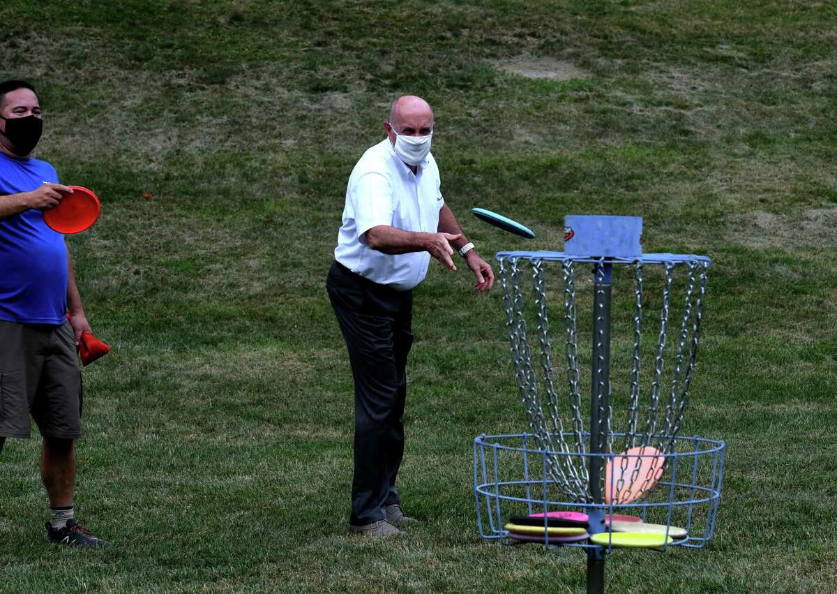 Troy Mayor Patrick Madden tries his hand at disc golf during the opening of a new nine-hole course in Prospect Park on Monday Aug. 3, 2020, in Troy, N.Y. Disc golf is played much like golf. However, instead of a ball and clubs, players use a flying disc or Frisbee with the objective of completing each hole in the fewest throws. (Will Waldron/Times Union)