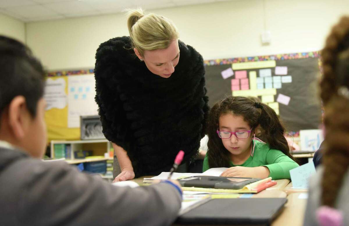 Then-assistant principal Klara Monaco talks with third-grader Dayanna Dies during the Teachers College training session at New Lebanon School in the Byram section of Greenwich, Conn. Tuesday, Nov. 29, 2016. The Columbia University Teachers College Reading and Writing Project came to New Lebanon for a professional development day promoting effective teaching strategies.
