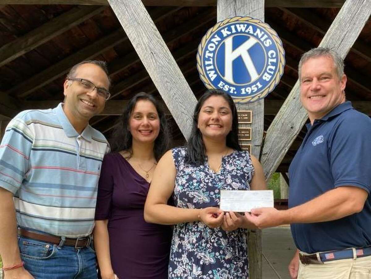 Megha Gupta, along with her parents, Deepender Gupta and Rakhee Agarwa, receives a scholarship from Jeff Turner, Wilton Kiwanis Club liaison to the Key Club. Megha, who graduated in June from Wilton High School, was honored for her work in Key Club as well as local organizations including the Wilton Volunteer Ambulance Corps and Wilton Community Emergency Response Team.