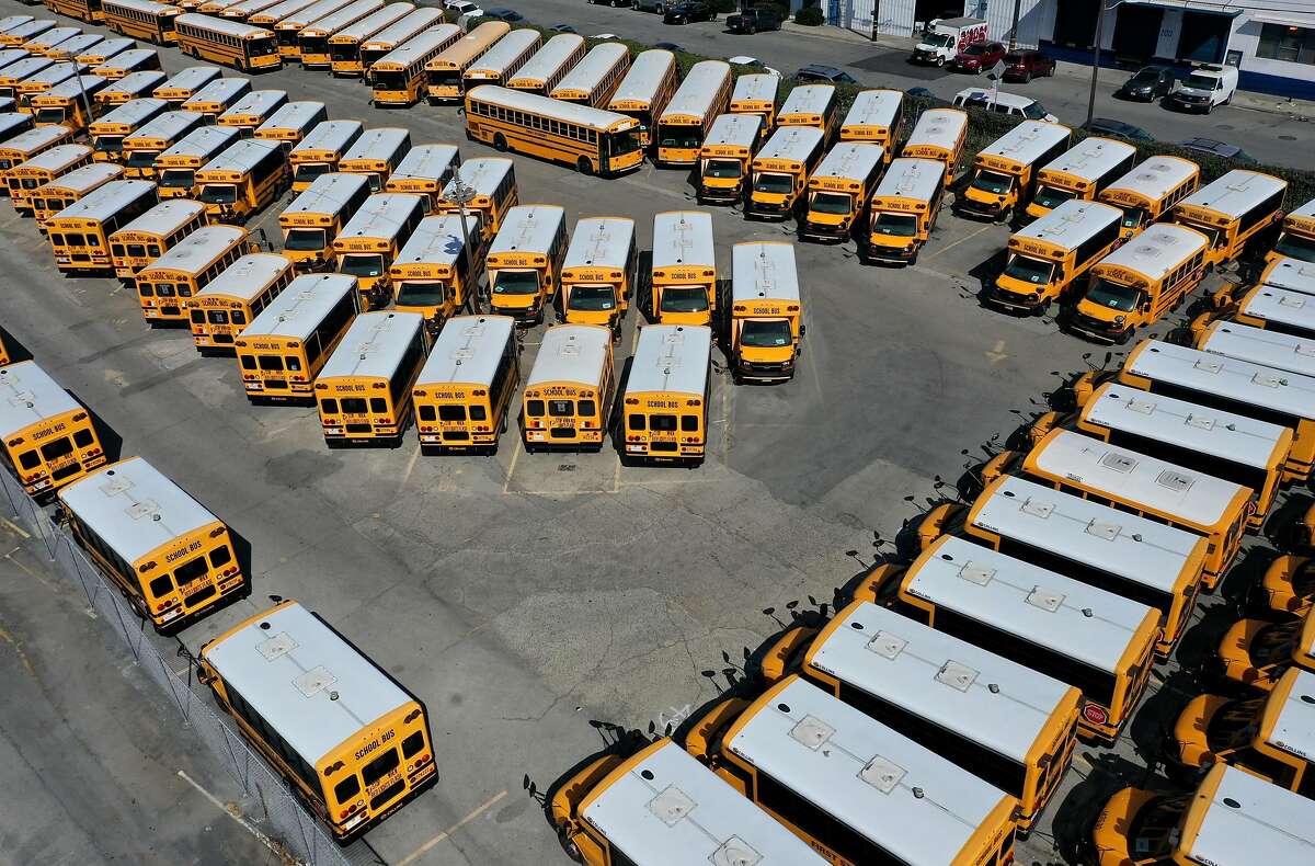 SAN FRANCISCO, CALIFORNIA - JULY 14: School buses sit parked in a lot at First Student Charter Bus Rental on July 14, 2020 in San Francisco, California. Los Angeles and San Diego public schools announced they will only offer a remote-only return to school August as coronavirus COVID-19 cases continue to rise in Southern California. (Photo by Justin Sullivan/Getty Images) *** BESTPIX ***