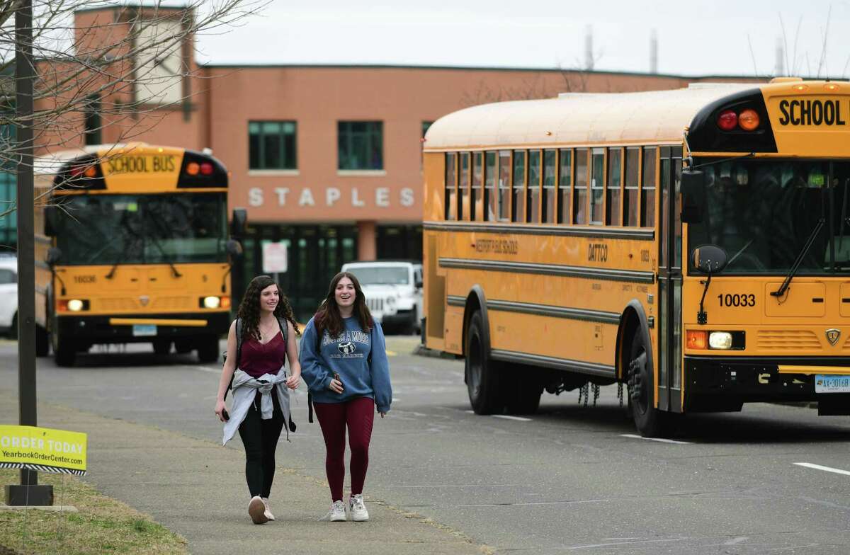 Students leave Staples High School on the announcement that Westport Schools will be closed for the unforeseeable future Wednesday, March 11, 2020, in response to the Covid-19 virus pandemic in Westport, Conn.