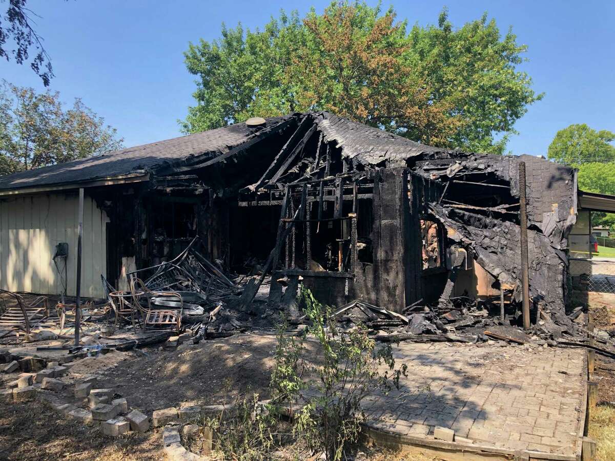 A Willis home engulfed by flames early Tuesday morning is seen hours after firefighters took out the blaze and rescued a teenager now in the hospital.