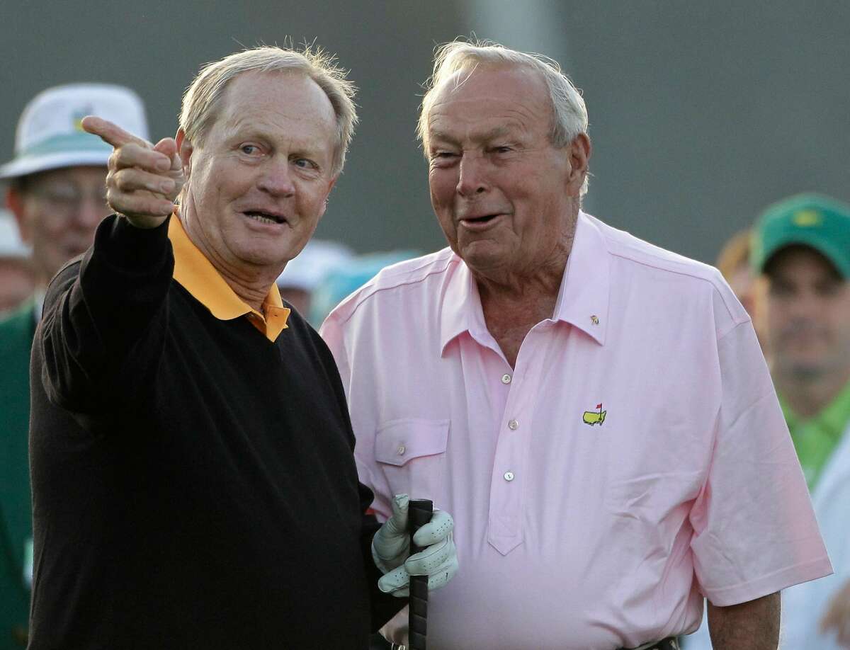 Jack Nicklaus, left, points the first fairway to Arnold Palmer during the ceremonial first tee shots during the first round of the Masters golf tournament in Augusta, Ga., Thursday, April 8, 2010. (AP Photo/Morry Gash)