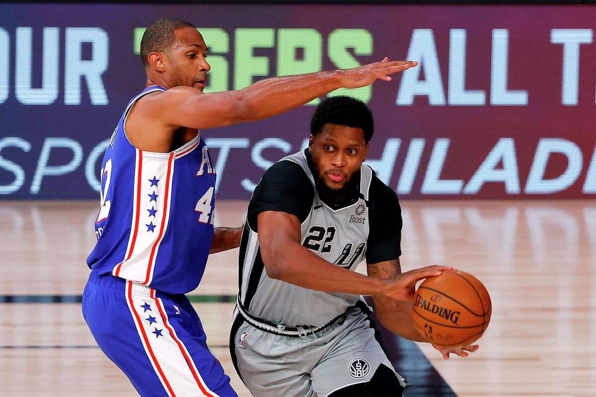 LAKE BUENA VISTA, FLORIDA - AUGUST 03: Rudy Gay #22 of the San Antonio Spurs is defended by Al Horford #42 of the Philadelphia 76ers during the first quarter at Visa Athletic Center at ESPN Wide World Of Sports Complex on August 03, 2020 in Lake Buena Vista, Florida. NOTE TO USER: User expressly acknowledges and agrees that, by downloading and or using this photograph, User is consenting to the terms and conditions of the Getty Images License Agreement. (Photo by Mike Ehrmann/Getty Images)