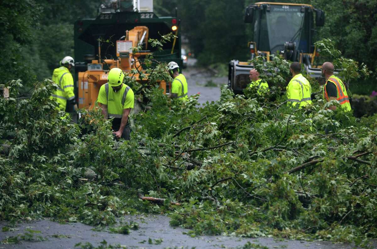 DPW crews clear fallen trees from Rae Street while wind gusted up to 70 miles per hour tearing down trees throughout the city as Tropical storm Isaias brings heavy rain Tuesday, August 4, 2020, to Norwalk, Conn.