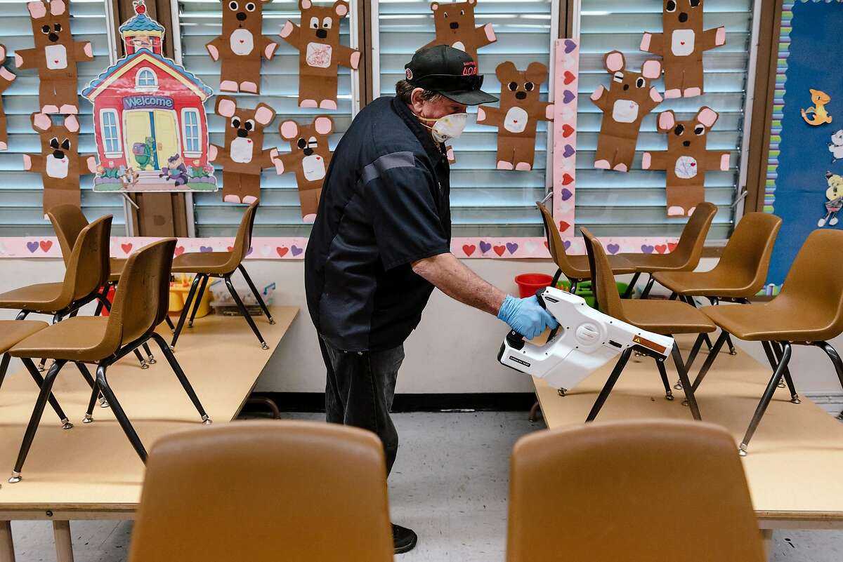 Fremont Unified School District mobile cleaning crew member Hoyt McCracken demonstrates the use of a Protexus electrostatic sprayer to disinfect a classroom at Joshua Chadbourne Elementary School in Fremont, California, on Tuesday, March 3, 2020.