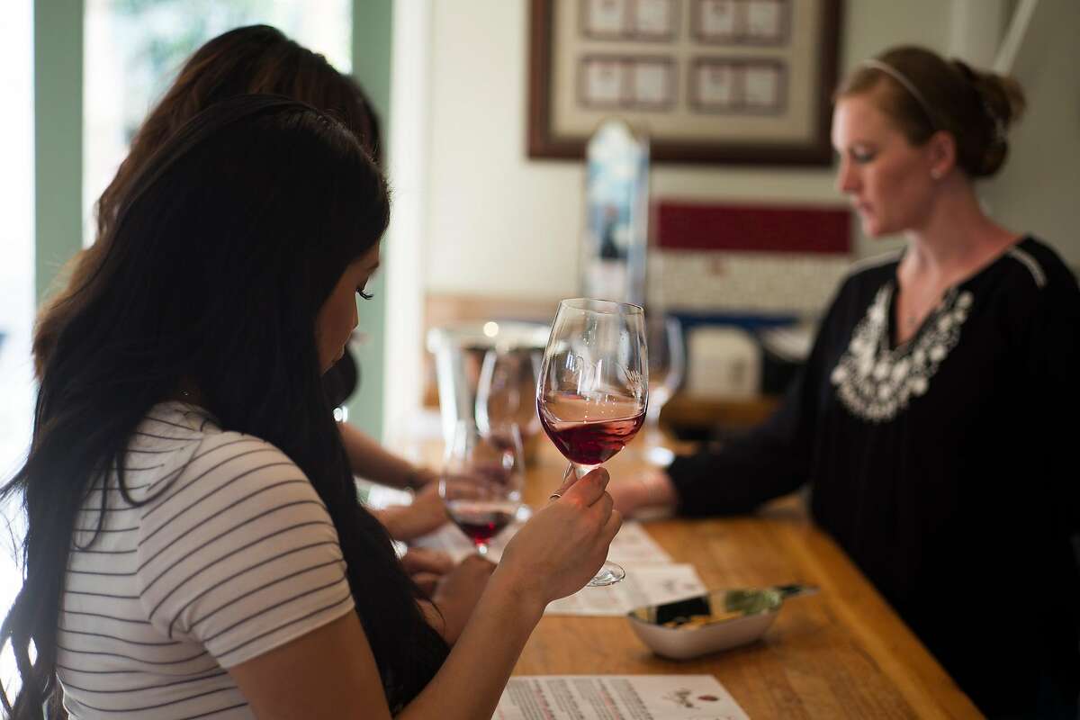 Tasting room associate Kristin Rice (right) entertains customers at Manzoni Estate Vineyards in Soledad, Calif.