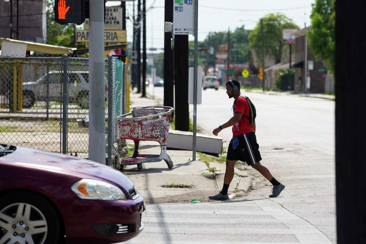 A man crosses Hogan Street at Fulton Street on Tuesday, Aug. 4, 2020, in the Near Northside neighborhood of Houston. The City of Houston is voting Wednesday on a new "Walkable Place" ordinance that would create new development rules to promote pedestrian-friendly areas in the city.