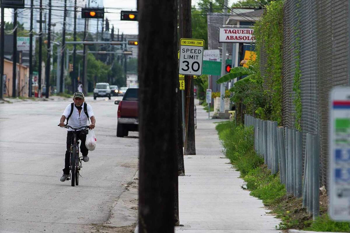 A man cycles down Hogan Street on Tuesday, Aug. 4, 2020, in the Near Northside neighborhood of Houston. The City of Houston is voting Wednesday on a new "Walkable Place" ordinance that would create new development rules to promote pedestrian-friendly areas in the city.