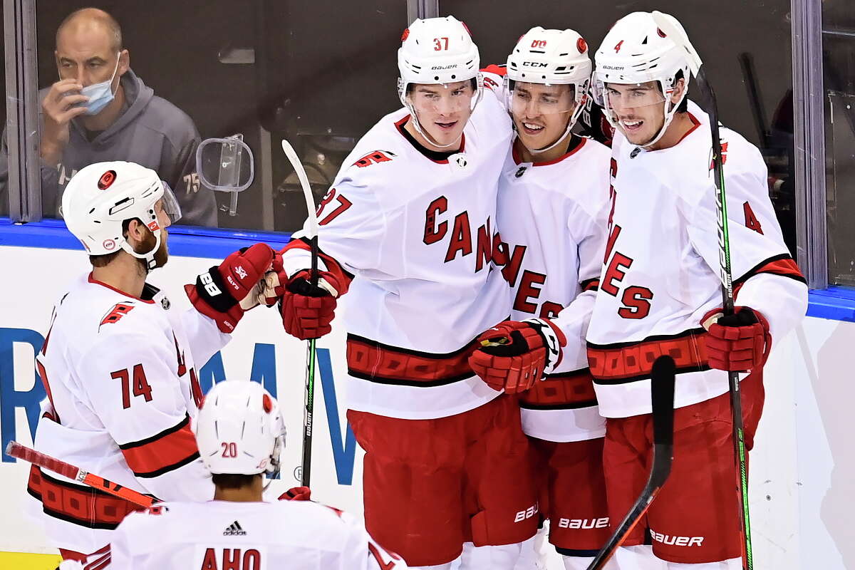 Carolina Hurricanes' Teuvo Teravainen, second from right, celebrates his goal against the New York Rangers with, from left, Jaccob Slavin, Sebastian Aho, Andrei Svechnikov and Haydn Fleury during the second period of an NHL hockey playoff game Tuesday, Aug. 4, 2020, in Toronto. (Frank Gunn/The Canadian Press via AP)