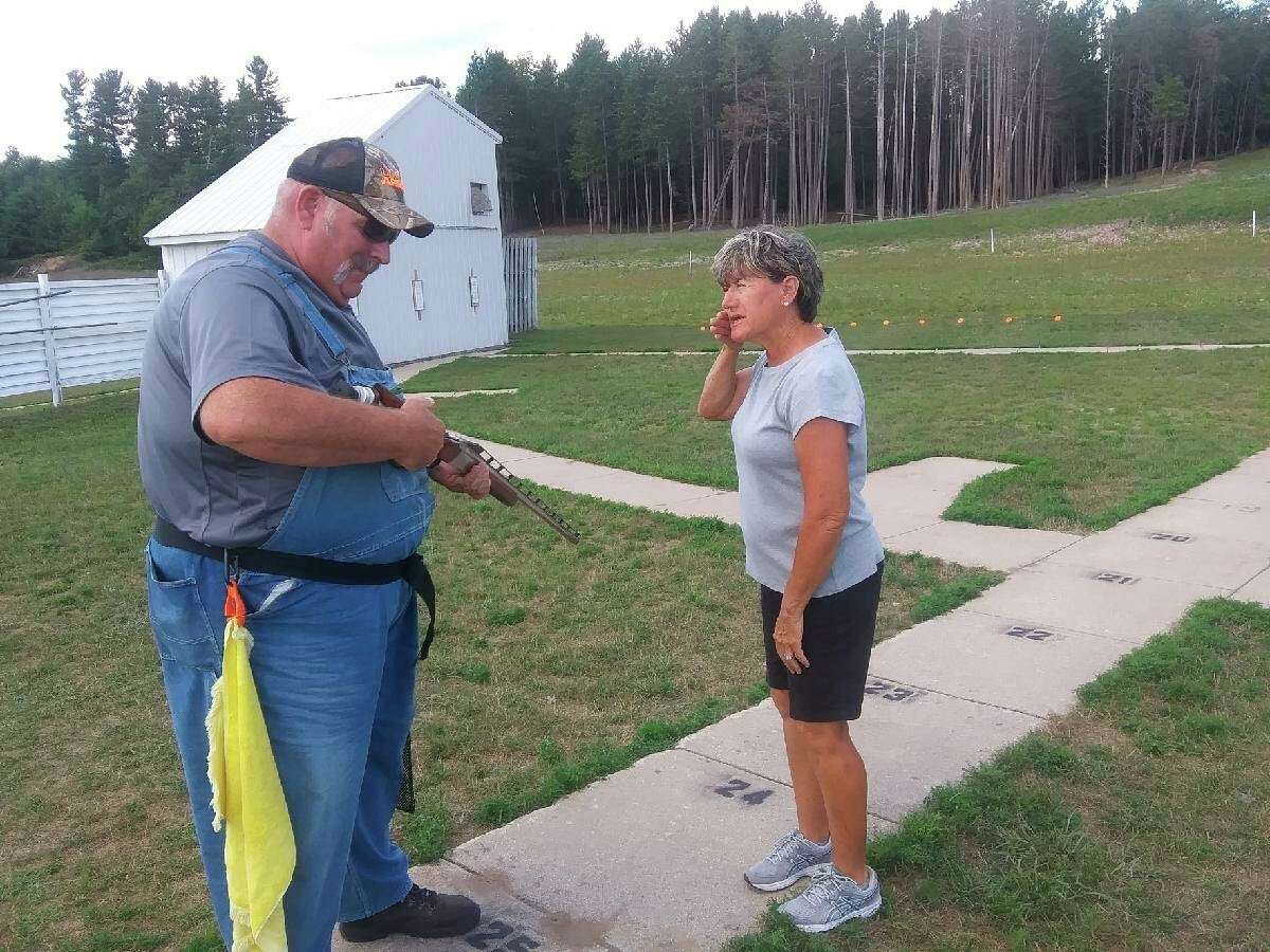 Trapshooting expert Nora Ross (right) instructs Mark Curtiss on the proper gun fit during a clinic last Thursday at the Reed City Sportsman Club. (Courtesy photo)