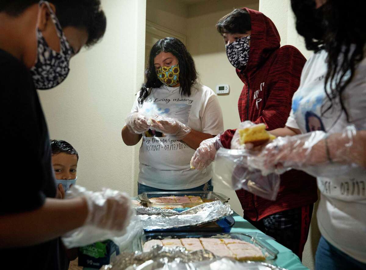 Family members work to put together food orders during a Aug. 1 benefit in Houston for Rosie Guevara, who died of COVID-19 at 59.
