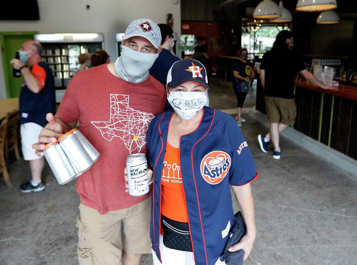 Lissa and Abel Rodriguez, of Katy with their to-go beer at New Magnolia Brewing during the first ever Houston Beer Run, Saturday, August 1, 2020, in Houston. The Houston Beer Run went to five different Inner Loop locations, encouraging fans of craft beer to buy to-go beer. The Houston Beer Run is an initiative to support the craft beer industry by encouraging people to place to-go orders at local breweries.