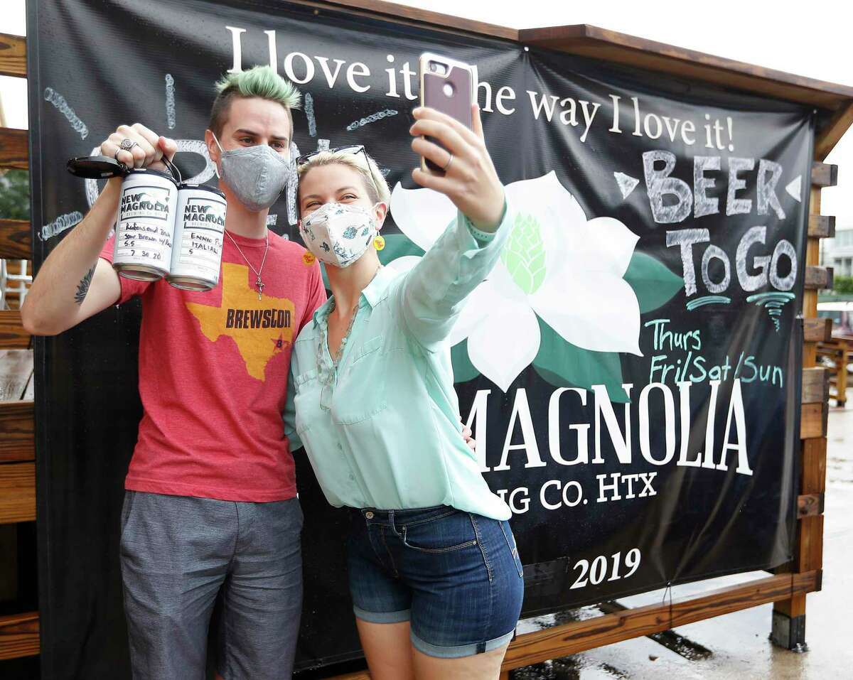 Kyle and Evan Rowland take s selfie at New Magnolia Brewing during the first ever Houston Beer Run, Saturday, August 1, 2020, in Houston. The Houston Beer Run went to five different Inner Loop locations, encouraging fans of craft beer to buy to-go beer. The Houston Beer Run is an initiative to support the craft beer industry by encouraging people to place to-go orders at local breweries.