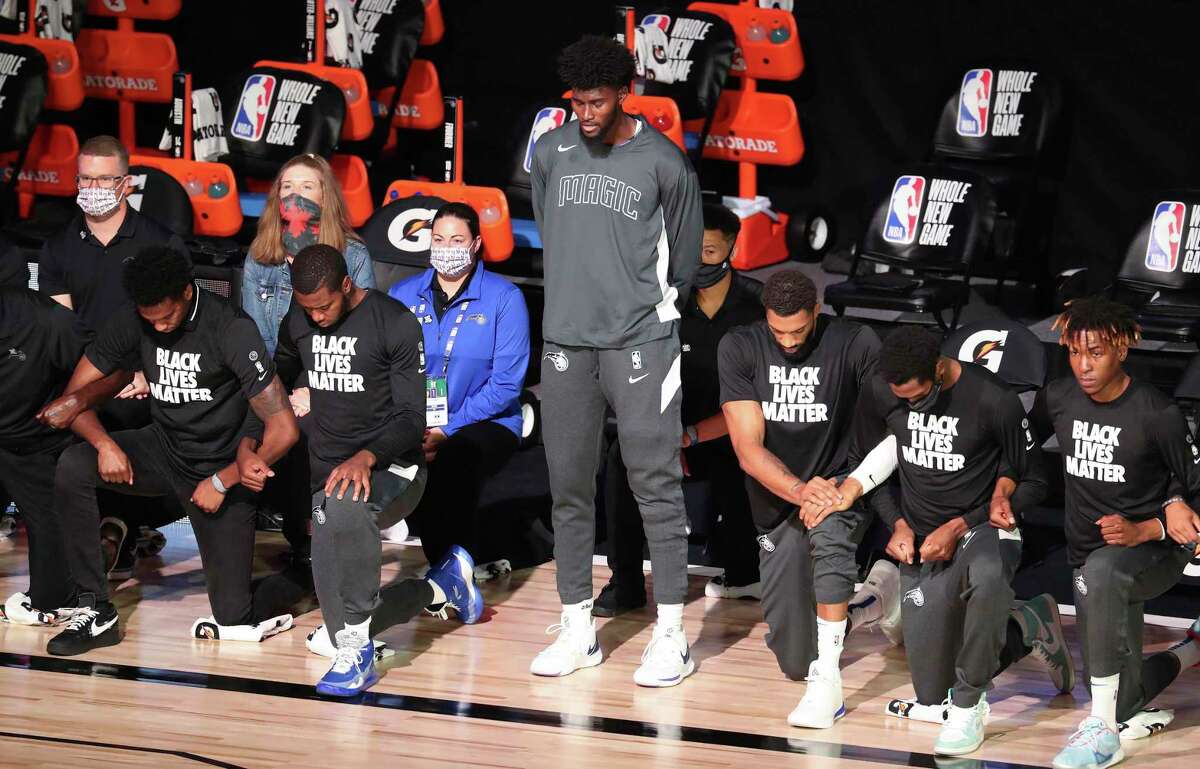 Orlando Magic player Jonathan Isaac stands during the national anthem before the team’s recent game against the Sacramento Kings on Sunday. A reader supports Isaac’s decision to stand, rather than kneel, during the anthem.