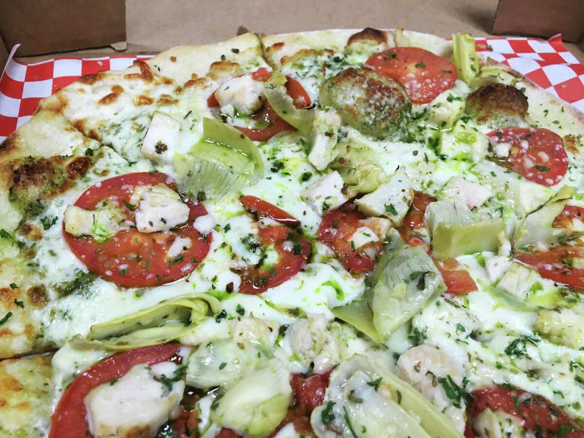 The chicken pesto pizza at Goomba's Pizzeria came with Alfredo sauce and was loaded with artichokes.