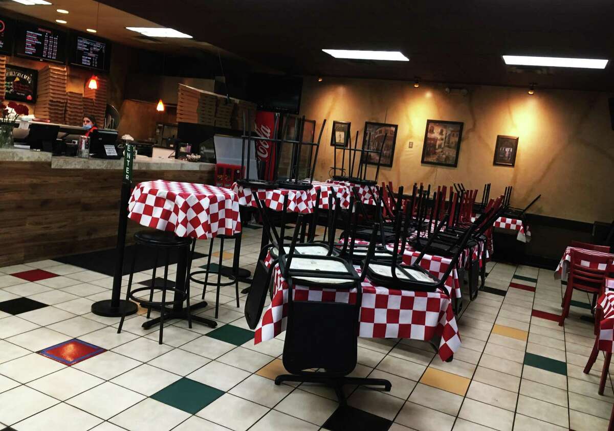 The interior dining space at Goomba's Pizzeria is outfitted with red checkered tablecloths and the smell of pizzas cooking in the oven hits you as you enter.