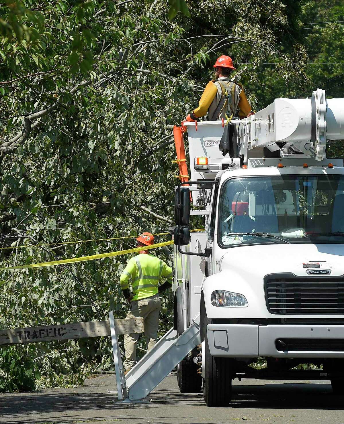 A utility crew from Asplundh Construction work to restore power in the Shippan neighborhood on August 5, 2020 in Stamford, Connecticut. Just 24 hours has passed since Tropical Storm Isaias pass through the region bringing heavy surf and damaging winds that has left over 9,000 Eversource customers in Stamford without power.
