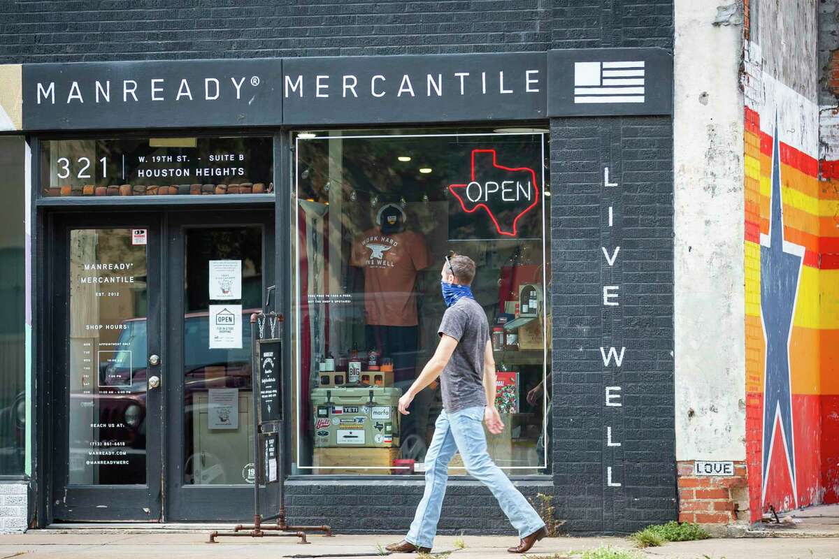 Pedestrians walk past Manready Mercantile next to a vacant lot along 19th Street in the Heights, Wednesday, Aug. 5, 2020, in Houston. A developer hoping to build in the empty lot had to approach the planning commission for a reprieve when they found that existing regulations would have forced them to build 25 feet back from the street. The city passed a "walkable places" ordinance Wednesday to allow more pedestrian-friendly buildings in certain pockets of Houston.