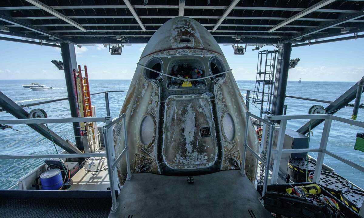 The SpaceX Crew Dragon Endeavour spacecraft, with NASA astronauts Bob Behnken and Doug Hurley onboard, is positioned on the SpaceX GO Navigator recovery ship shortly after landing in the Gulf of Mexico off the coast of Pensacola, Fla., on Aug. 2, 2020.