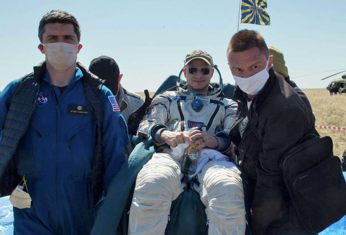 In this handout photo released by Gagarin Cosmonaut Training Centre, Roscosmos space agency, rescue team members carry U.S. astronaut Andrew Morgan shortly after the landing of the Russian Soyuz MS-15 space capsule near Kazakh town of Dzhezkazgan, Kazakhstan, Friday, April 17, 2020.