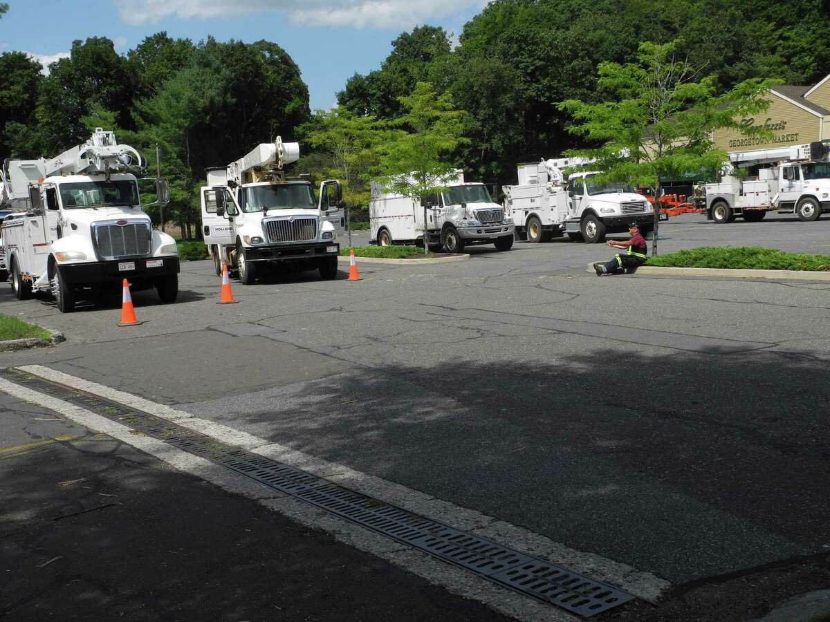 Crews with utility trucks down from Brunswick, Canada, await their orders Wednesday at Carluzzi's Georgetown Market in Wilton, Conn., on Aug. 5, 2020.