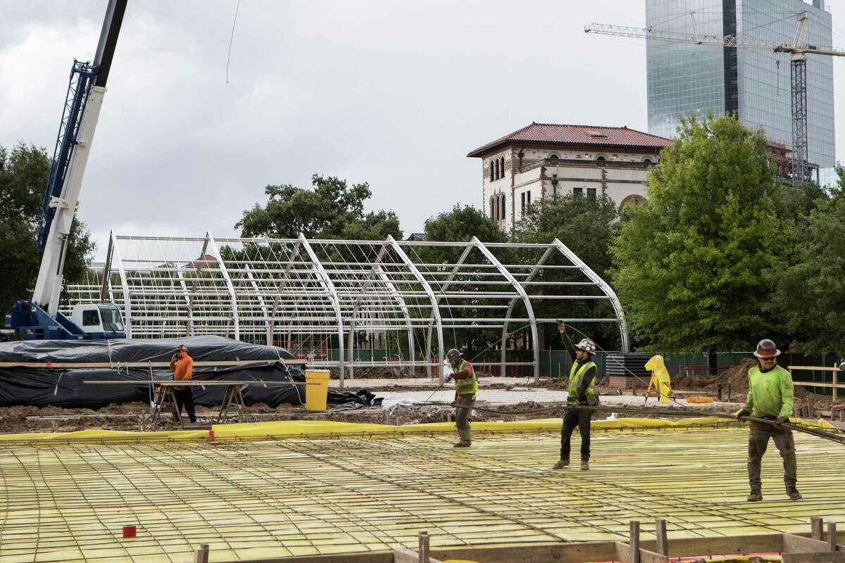 Construction workers continue the work of building semi-permanent outdoor structures on the Rice University campus Wednesday, July 29, 2020 in Houston. The buildings, which will also be able to be moved, are slated to be used to host classrooms and activities, in hopes of maintaining social distancing guidelines amid the COVID-19 pandemic this fall.