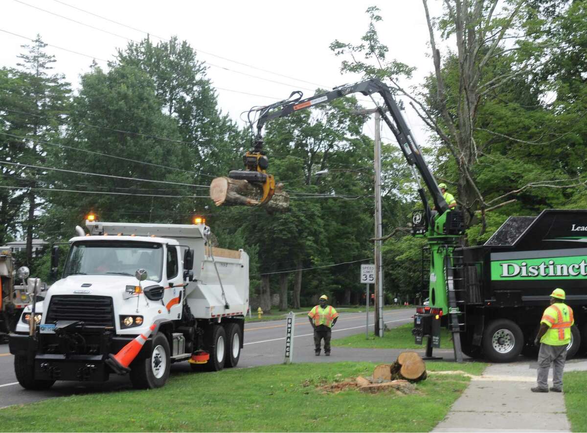 Crews were at work cleaning up downed trees and wires on Main Street, near Rockwell Road, on Thursday.