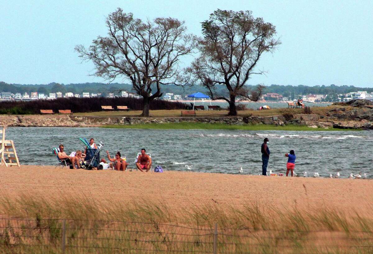 People enjoy the beach in West Haven, Conn., on Thursday Aug. 6, 2020.