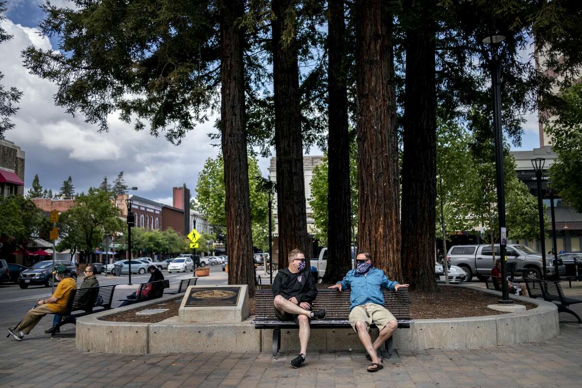 As evening approaches folks gather in a quiet Old Courthouse Square in downtown Santa Rosa, as California implements Phase 3 its state-wide economy opening plan during the coronavirus pandemic in Santa Rosa, California on Friday June 12, 2020.
