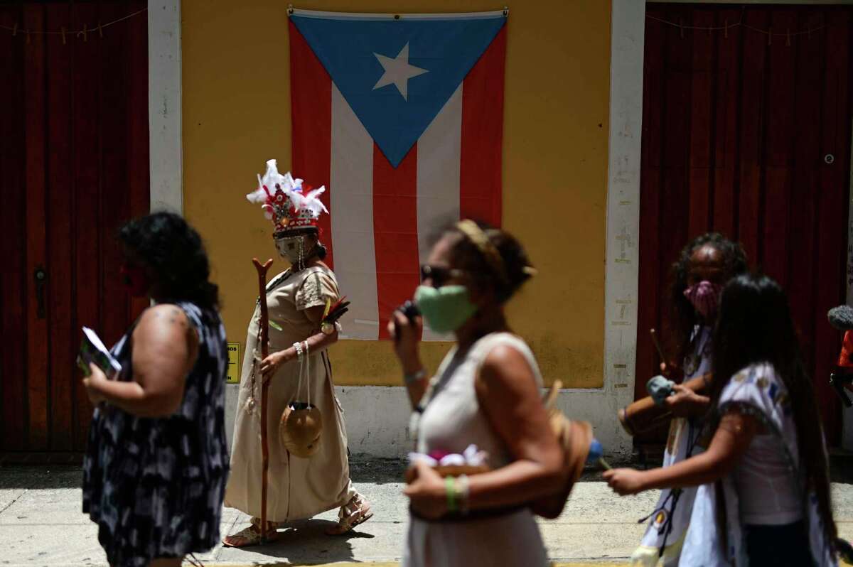 In July photo, activists in Puerto Rico demand the removal of symbols of colonial oppression. It’s time the United States clarified its relationship with Puerto Rico.
