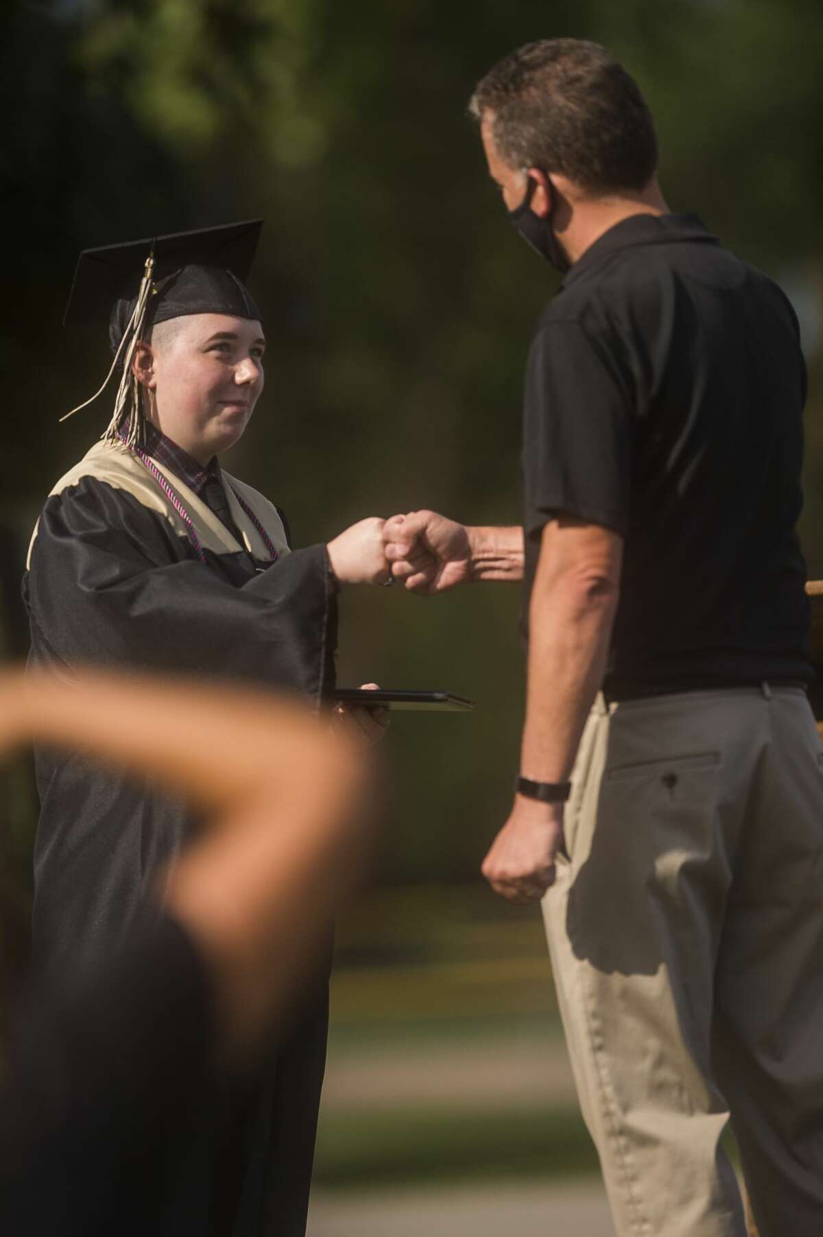 Graduating seniors from Bullock Creek High School celebrate with family and friends during a commencement ceremony Friday, Aug. 7, 2020 at the school. (Katy Kildee/kkildee@mdn.net)