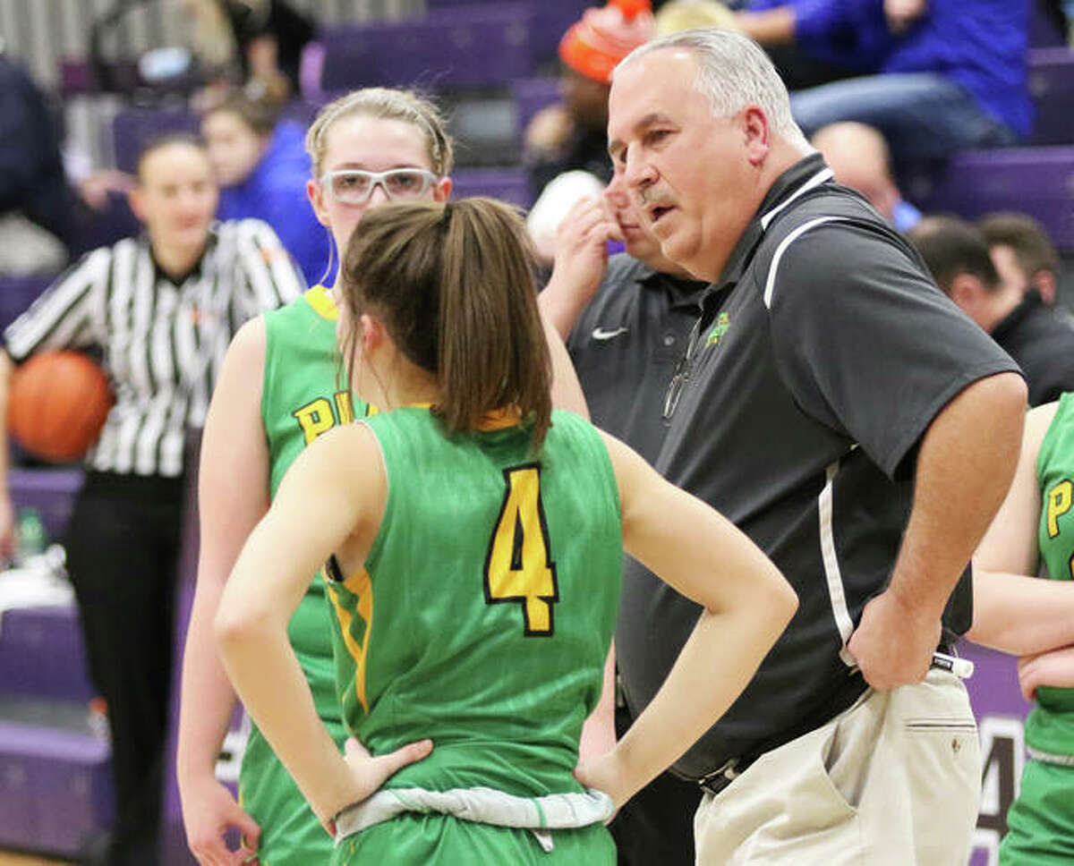 Southwestern girls basketball coach Steve Wooley (right) talks with junior Josie Bouillon (4) while Annie Gallaher looks on during a game vs. Nashville at the Breese Central Shootout on Jan. 4 in Breese. Wooley, also the school’s athletics director, is entering his final year in both those roles before retirement in 2021.