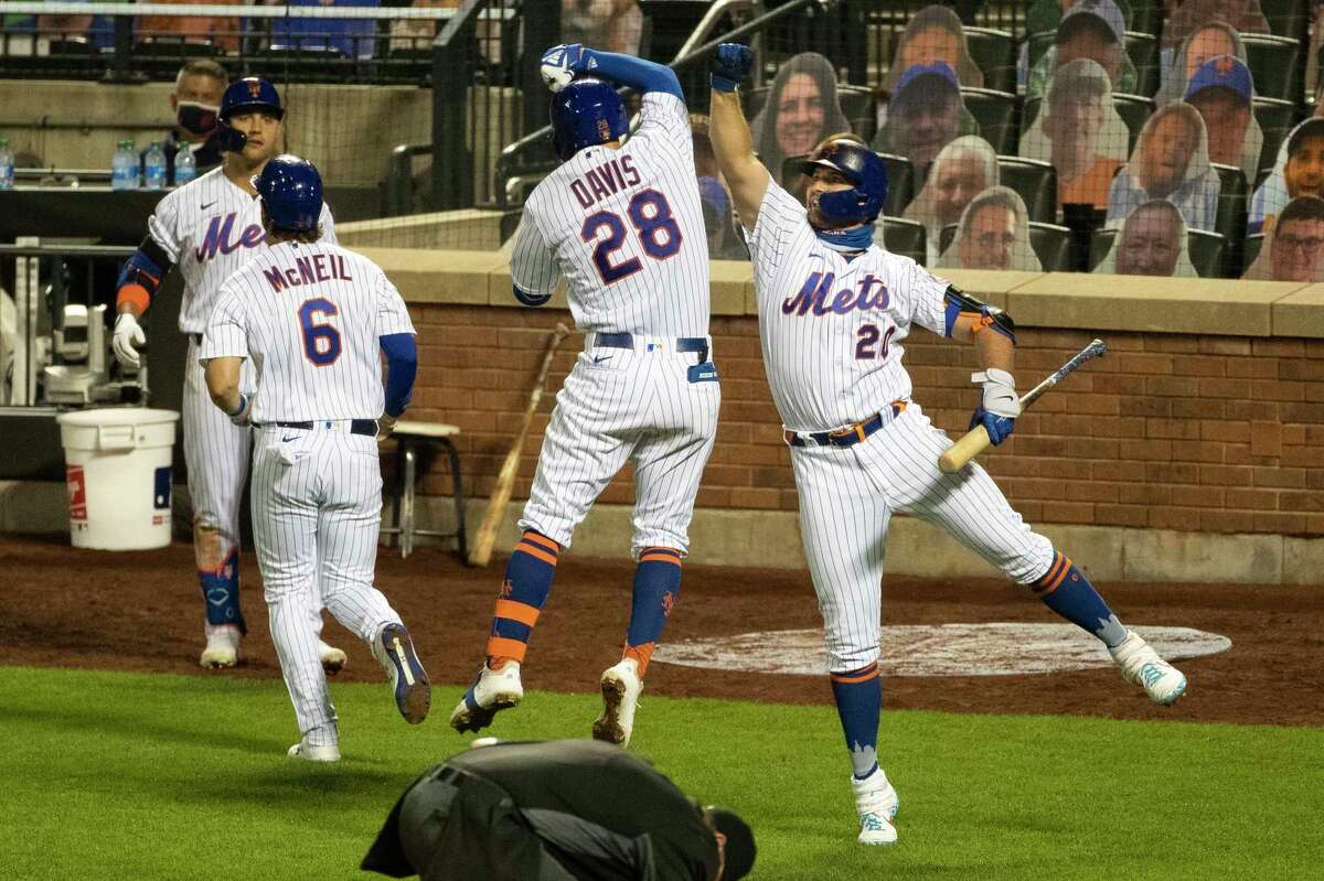 New York Mets' J.D. Davis (28) celebrates with teammate Pete Alonso (20) after hitting a three-run home run during the seventh inning of a baseball game against the Miami Marlins Saturday, Aug. 8, 2020, in New York. (AP Photo/Frank Franklin II)