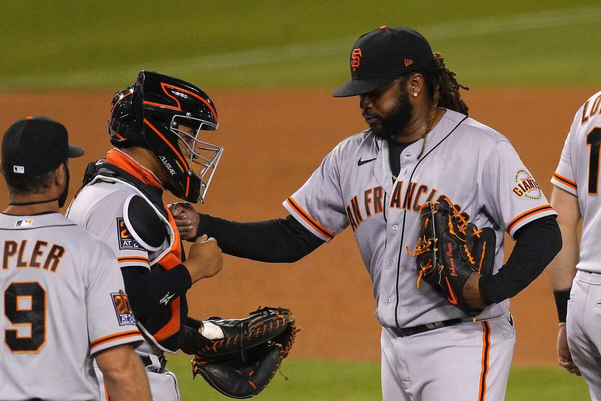 San Francisco Giants starting pitcher Johnny Cueto, right, pats catcher Chadwick Tromp, center, on the chest before being taken out of a baseball game by manager Gabe Kapler during the sixth inning against the Los Angeles Dodgers, Saturday, Aug. 8, 2020, in Los Angeles. (AP Photo/Mark J. Terrill)