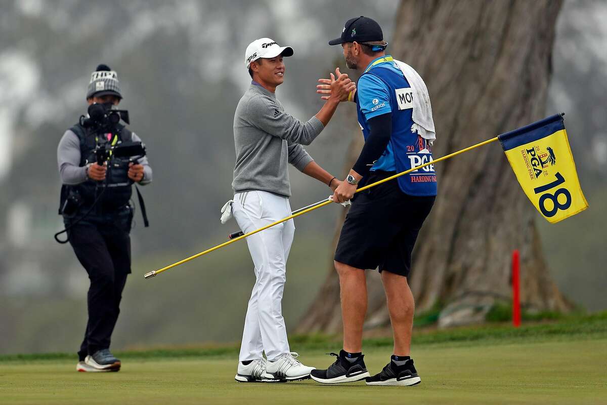 Collin Morikawa celebrates with his caddie after parring 18th hole and winning PGA Championship with a final round of 64 (-6) and -13 for the tournament at TPC Harding Park in San Francisco, Calif., on Sunday, August 9, 2020.