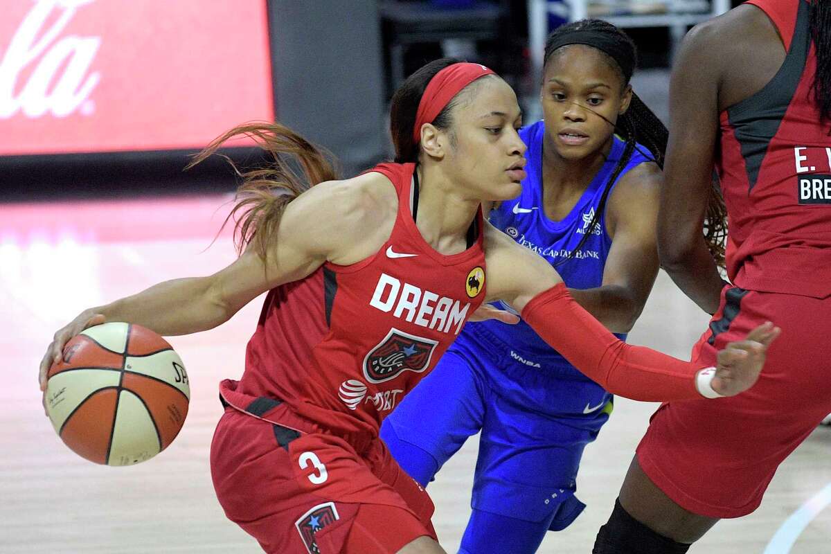 Atlanta Dream guard Chennedy Carter (3) drives past Dallas Wings guard Moriah Jefferson during the first half of a WNBA basketball game Sunday, July 26, 2020, in Bradenton, Fla.