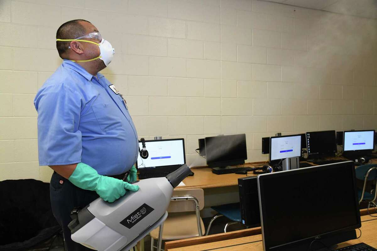 LISD custodians give media a presentation of the misting units used to sanitize classrooms during the pandemic.