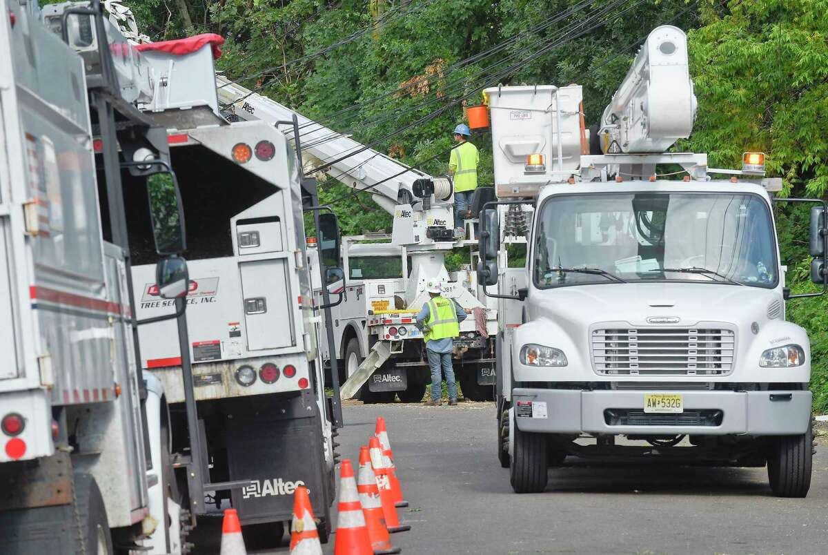 A utility crew works to erect a downed pole following Tropical Storm Isaias. Many out of state crews have been brought in to assist Eversource in restoring power to the region and help with clean-up of storm debris.