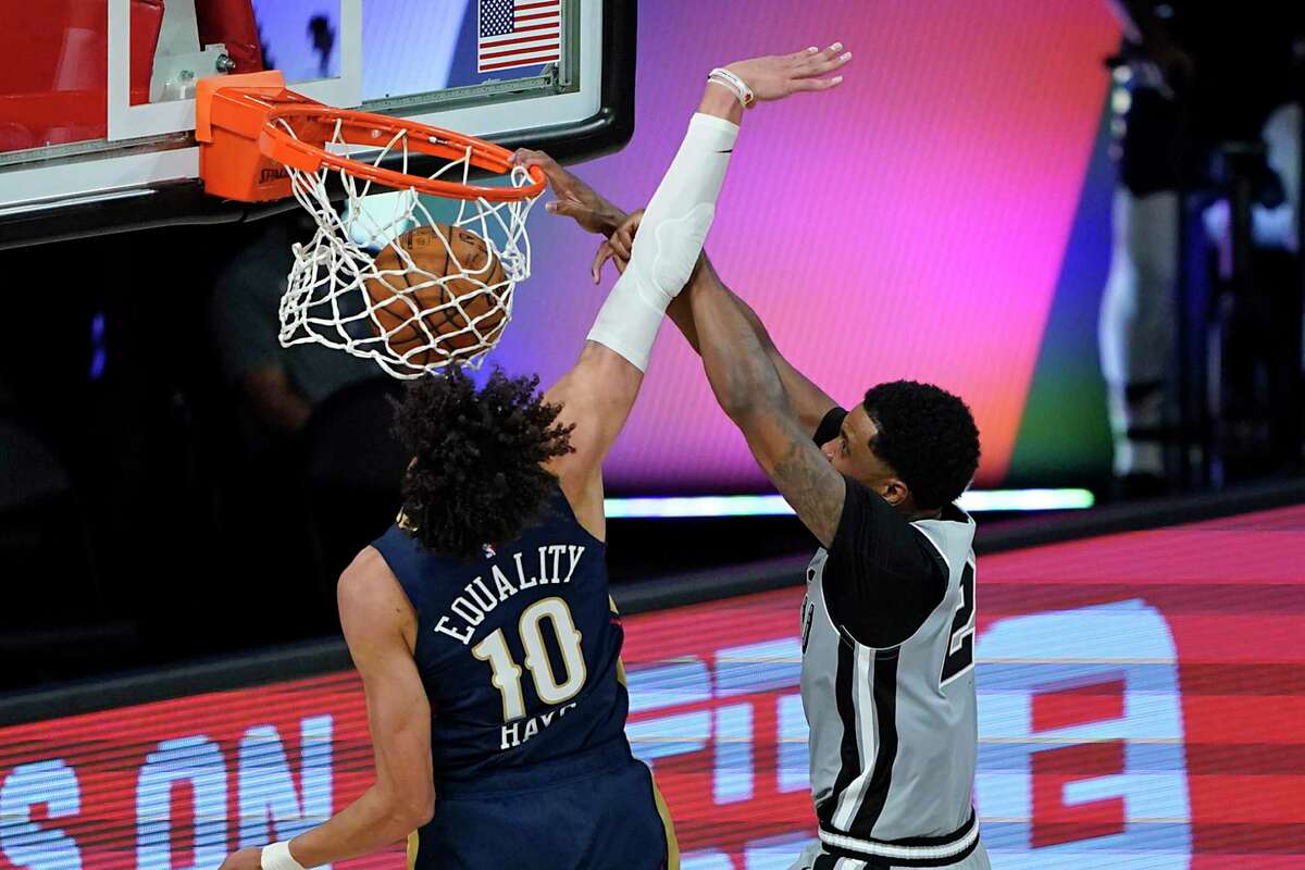 San Antonio Spurs' Rudy Gay, right, dunks the ball as he gets past New Orleans Pelicans' Jaxson Hayes (10) during the second half of an NBA basketball game, Sunday, Aug. 9, 2020, in Lake Buena Vista, Fla. (AP Photo/Ashley Landis, Pool)