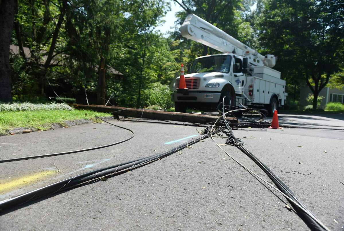 Crews repair powerlines on Angelus Drive in Glenville downed six days after Tropical Storm Isaias hit Greenwich, Conn. Monday, Aug. 10, 2020.