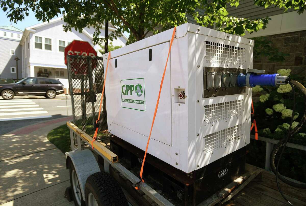 A generator powers a business in the aftermath of a Tropical Storm Isaias in the still dark Saugatuck section of Westport, Conn. on Monday, August 10, 2020.