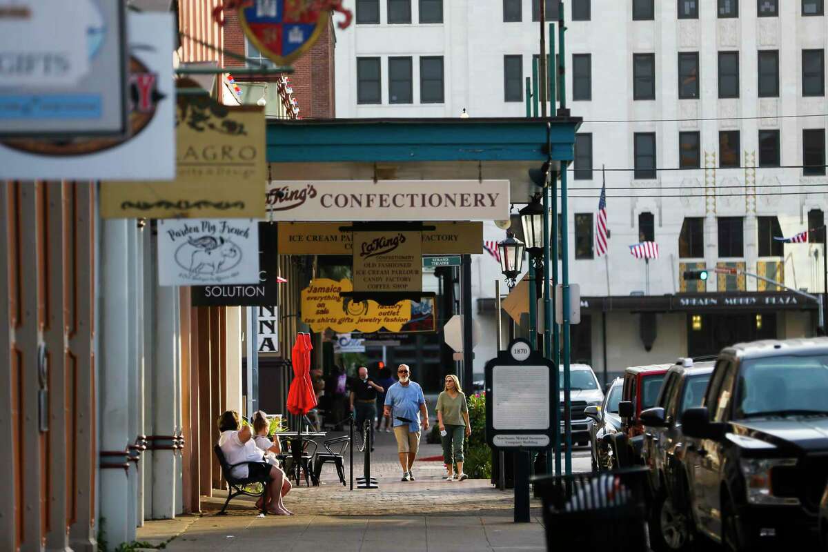People walk through the Strand, Thursday, July 16, 2020, in Galveston.