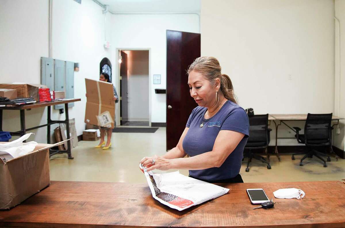 Mely Jimenez  works in her business, Today's Business Solutions, in Houston on Monday, Aug. 10, 2020.  The family-run business had to cut staff by more than half, to seven from 17.