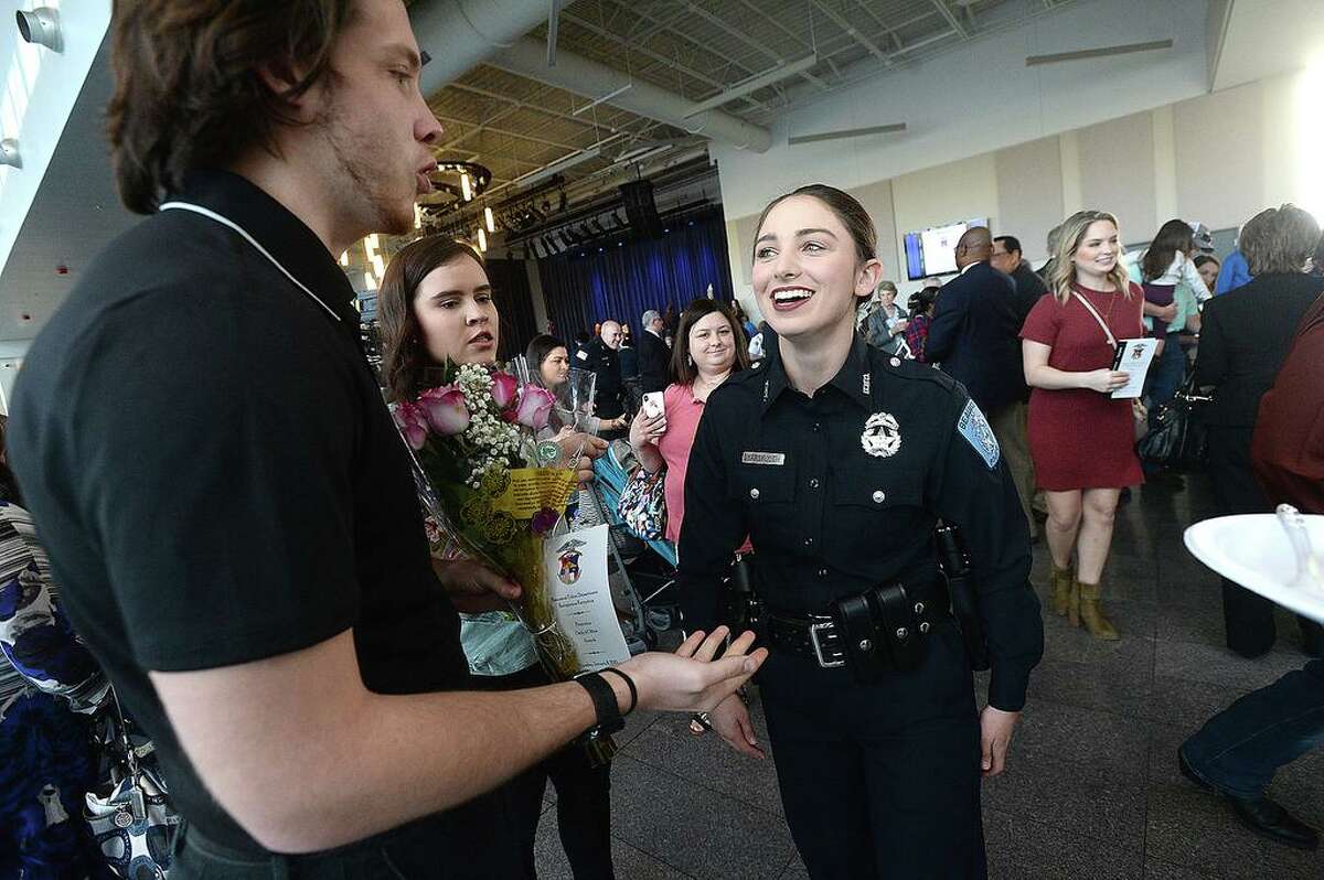 Beaumont Police officer Sheena Yarbrough talks with her boyfriend Tyler Powell, who brought flowers to congratulate her after joining 11 others sworn into office during a milestones ceremony Tuesday at the Event Centre. Twelve new officers were sworn in, officer Cody Foote was recognized for his promotion to Sergeant, and other officer and civilian awards were presented during the event. Photo taken Tuesday, January 8, 2019 Photo by Kim Brent/The Enterprise