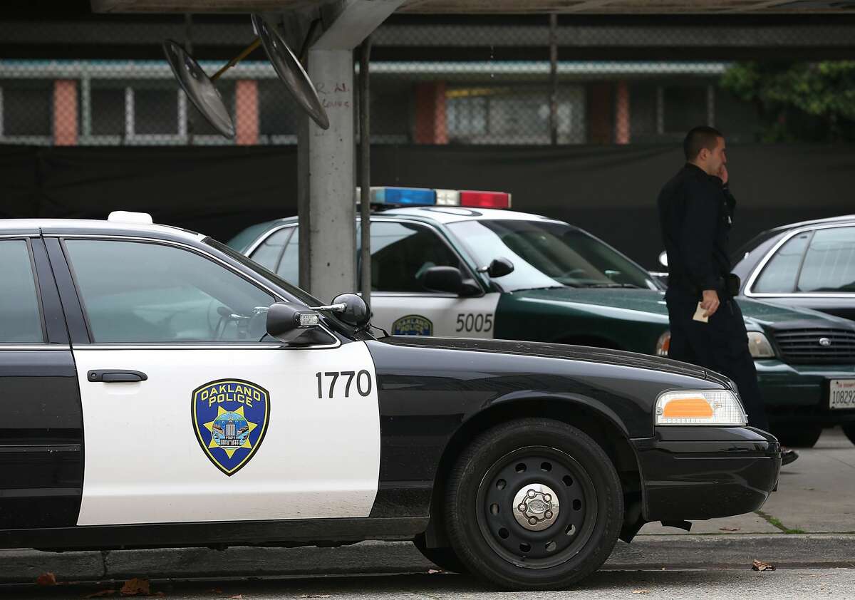 An Oakland Police officer walks by patrol cars at the Oakland Police headquarters on December 6, 2012 in Oakland, California.